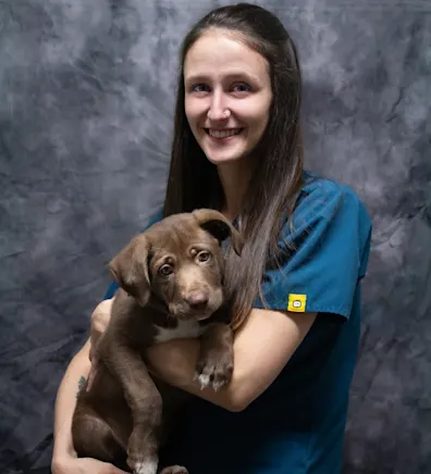 Heidi holding a brown dog