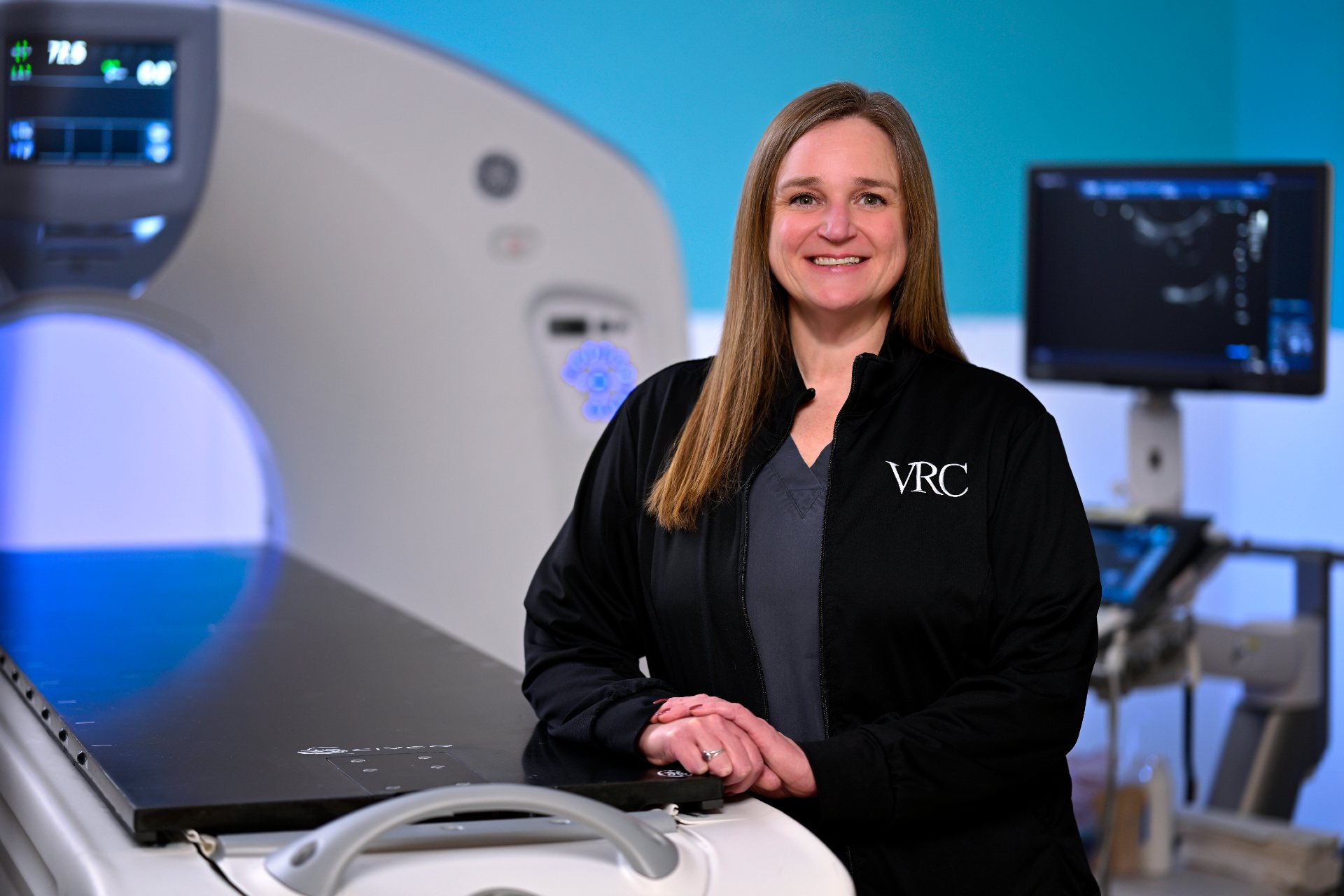 Jill Graff standing next to an MRI machine.