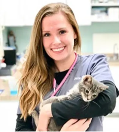 Jane Miller smiling holding a grey kitten Jane Miller smiling holding a grey kitten