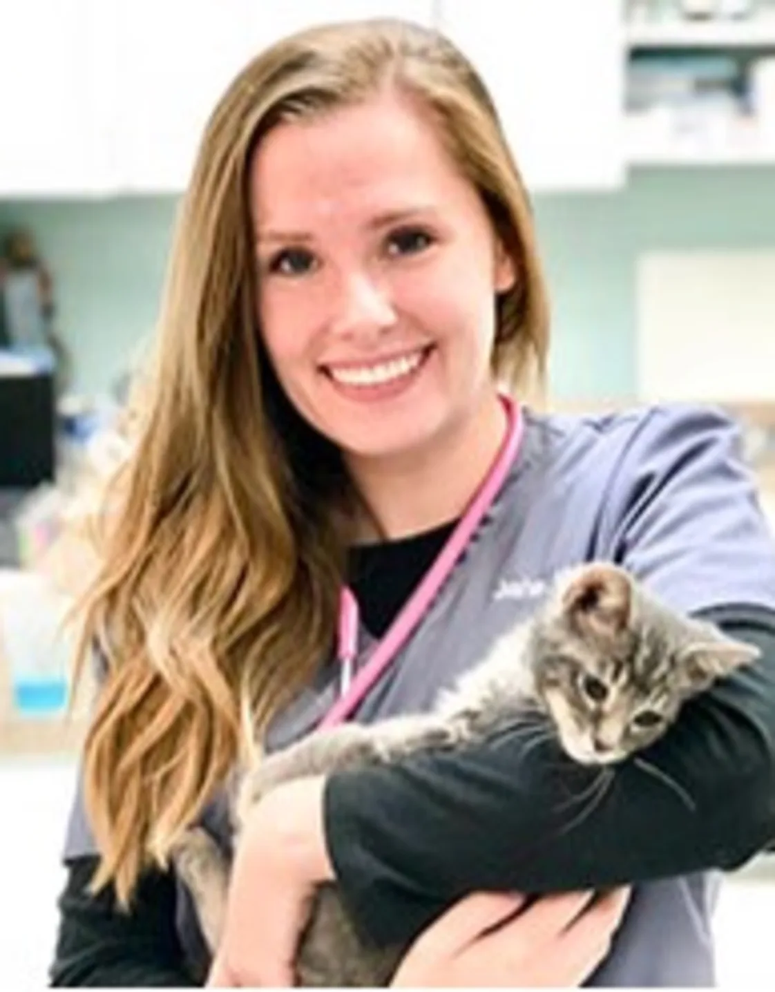 Jane Miller smiling holding a grey kitten Jane Miller smiling holding a grey kitten