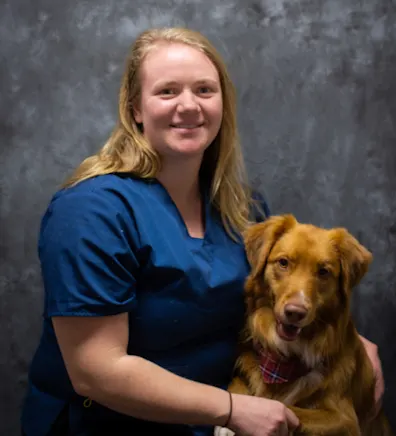 Samantha holding a tan dog