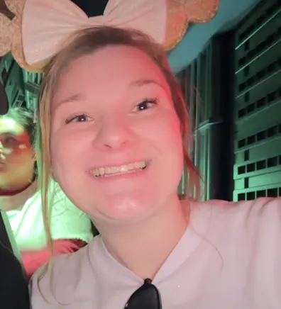 Kristen Triblle smiling with a white t-shirt and a headband with a bow Kristen Triblle smiling with a white t-shirt and a headband with a bow