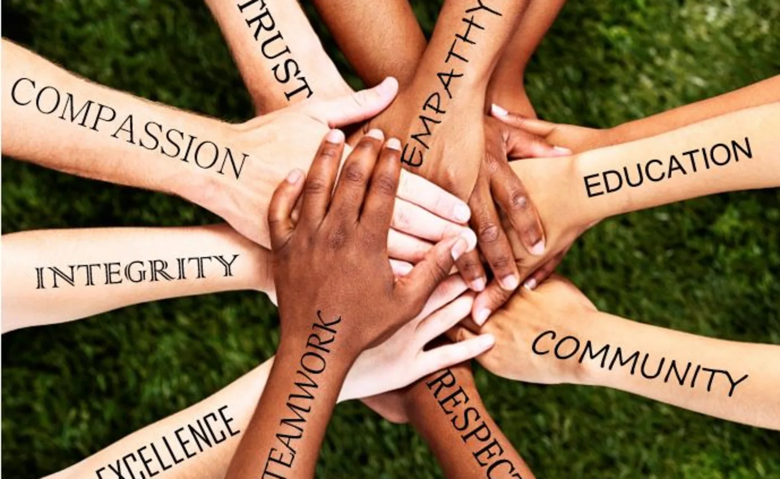 Hands in a pile with encouraging words Hands in a pile with encouraging words