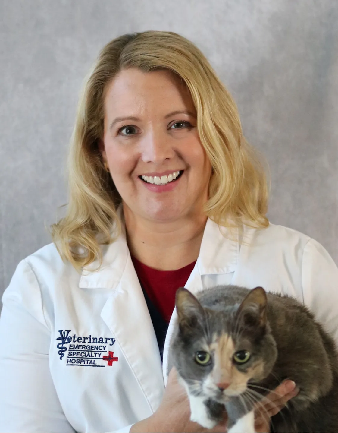 Dr. Amy Totten holding her brown cat for her staff photo. Dr. Amy Totten holding her brown cat for her staff photo.