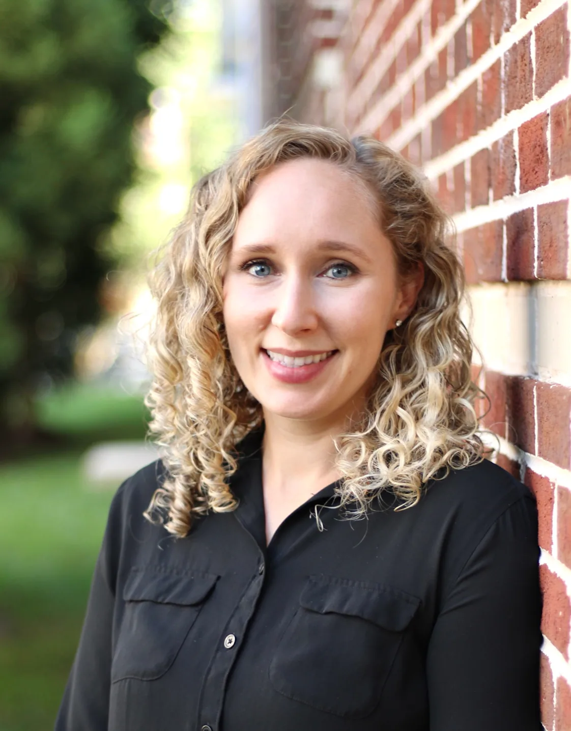 Lindsay Wood outside with a black blouse. Lindsay Wood outside with a black blouse.