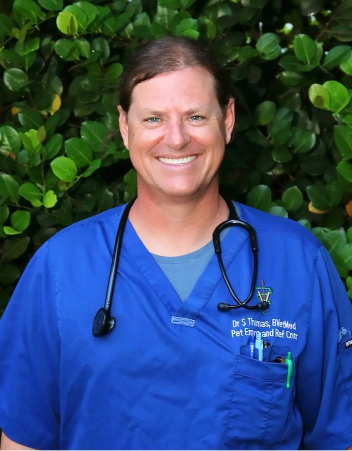 Dr. Sean Thomas Holding a two dogs Dr. Sean Thomas Holding a two dogs