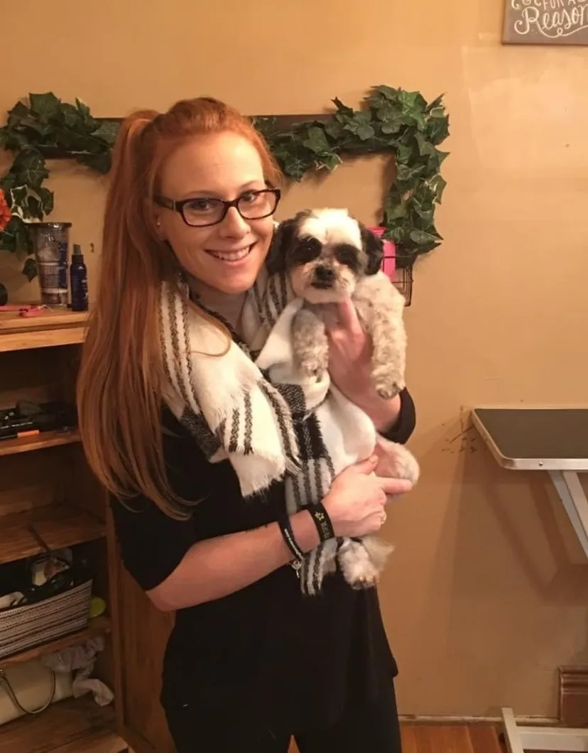Andrea holding small black and white dog