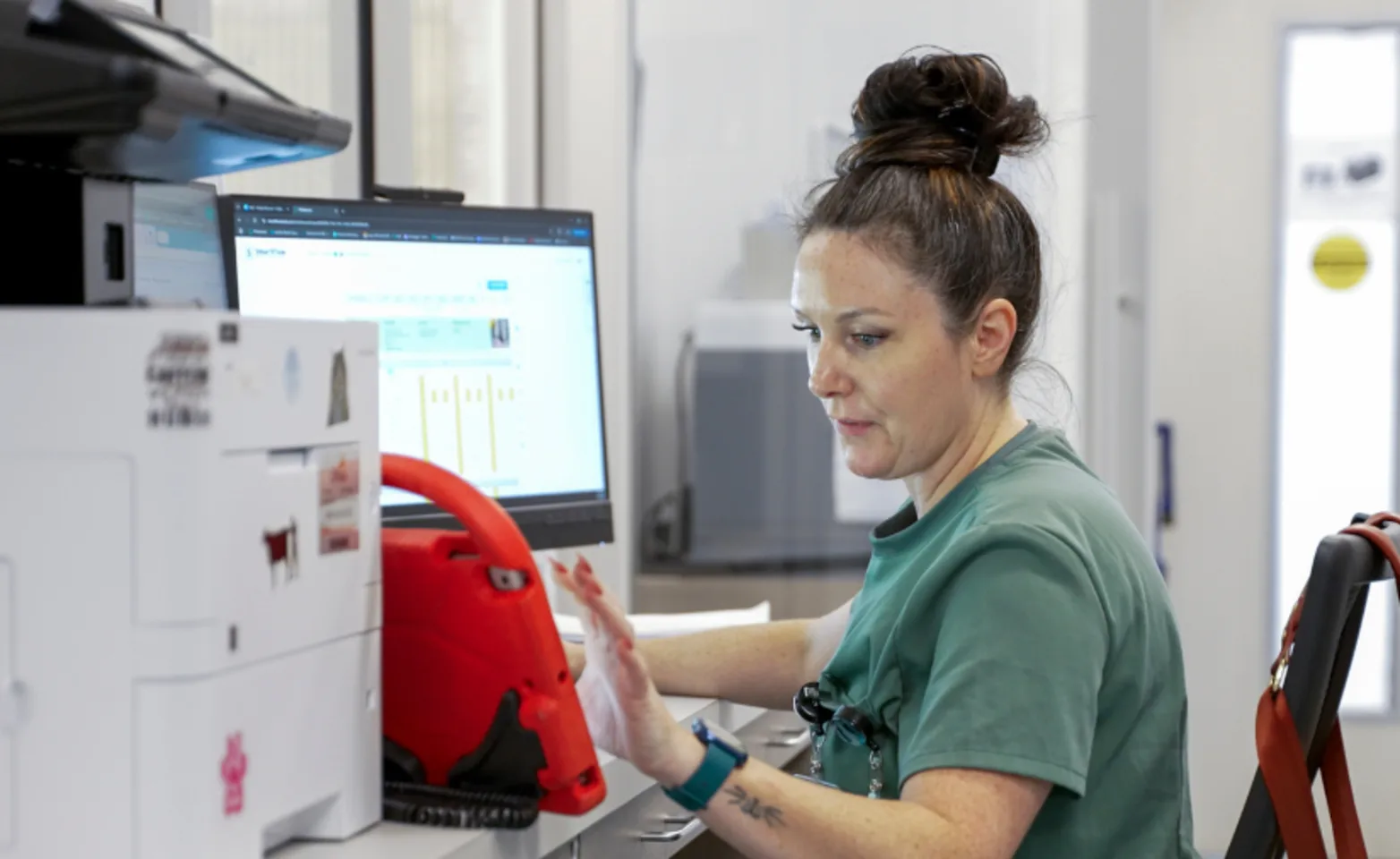 A team member working on the computer A team member working on the computer