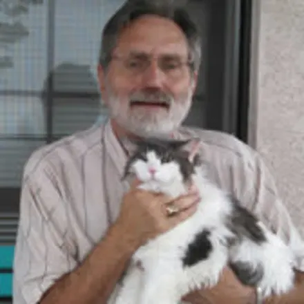 Dr. Mohr holding a black and white cat