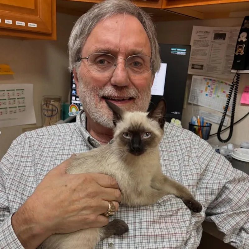 Dr. Mohr holding a black and white cat Dr. Mohr holding a black and white cat