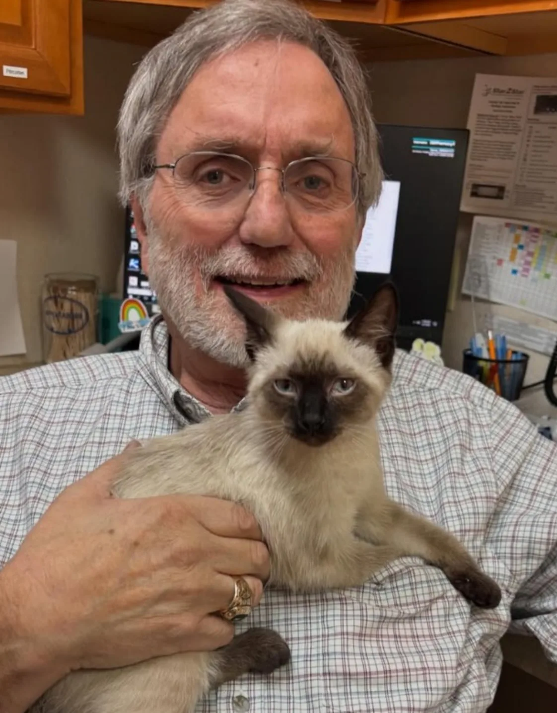 Dr. Mohr holding a black and white cat Dr. Mohr holding a black and white cat