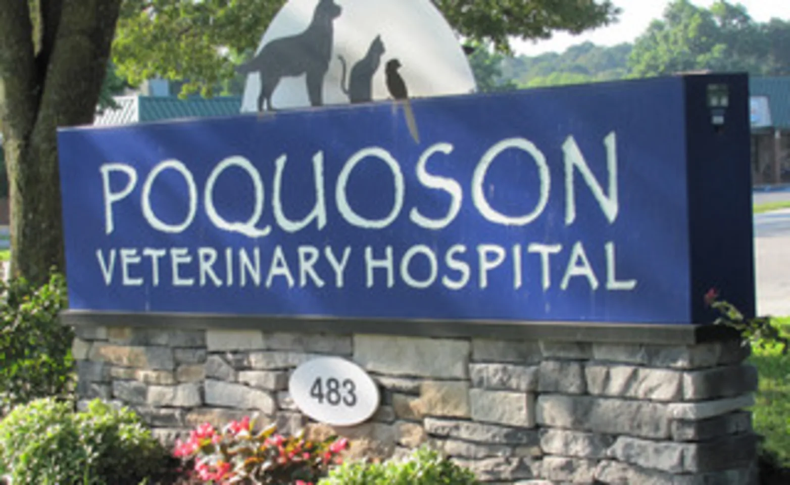 Poquoson Veterinary Hospital's outdoor brick signage with their address number on it. 