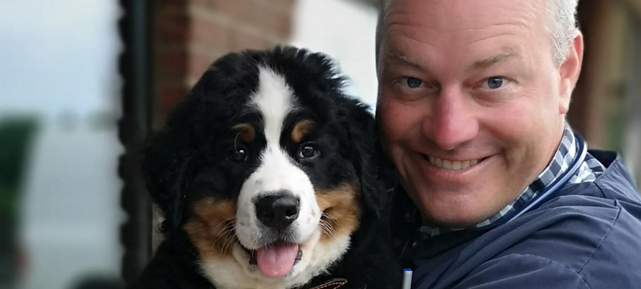 Dr. Kaufmann smiling with shepherd dog Dr. Kaufmann smiling with shepherd dog