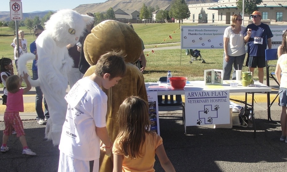 Mascots and attendees at an event hosted by Arvada flats veterinary hospital