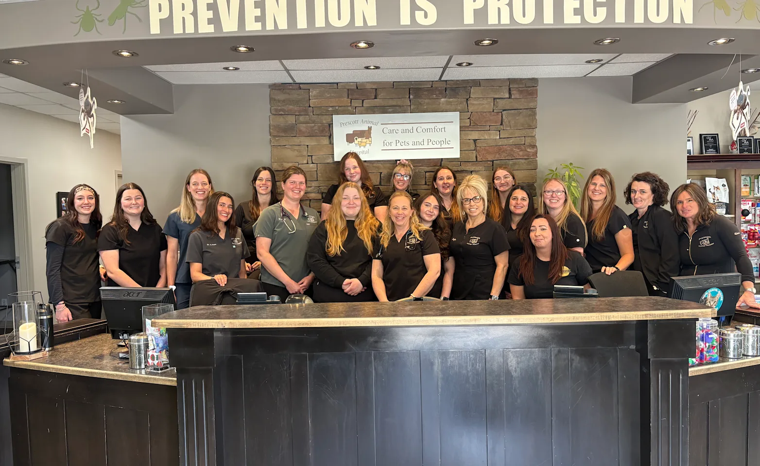 Team in front of front desk Team in front of front desk