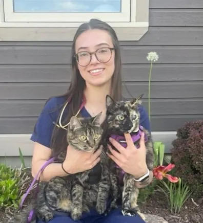 Molly sitting with her two cats Molly sitting with her two cats