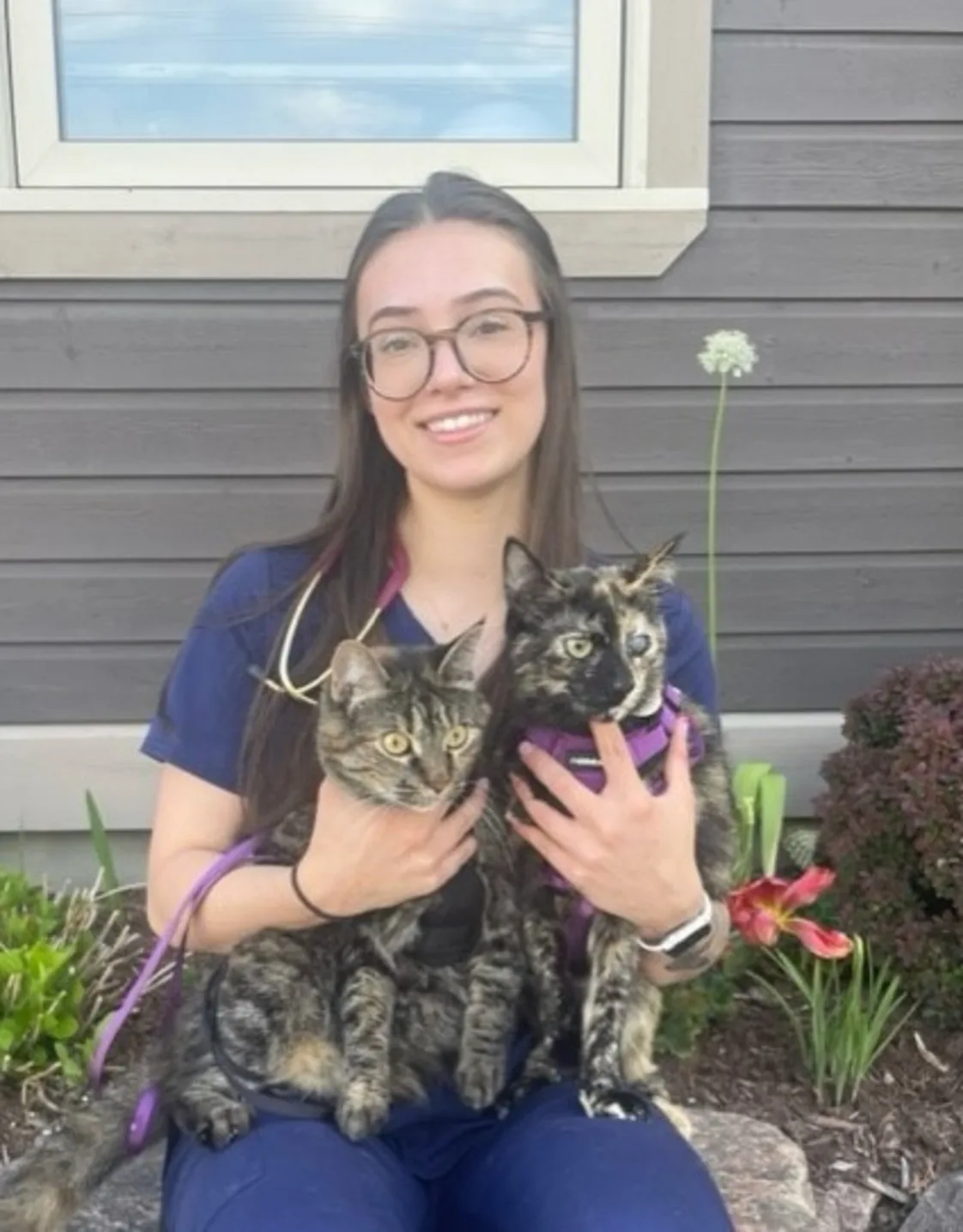 Molly sitting with her two cats Molly sitting with her two cats