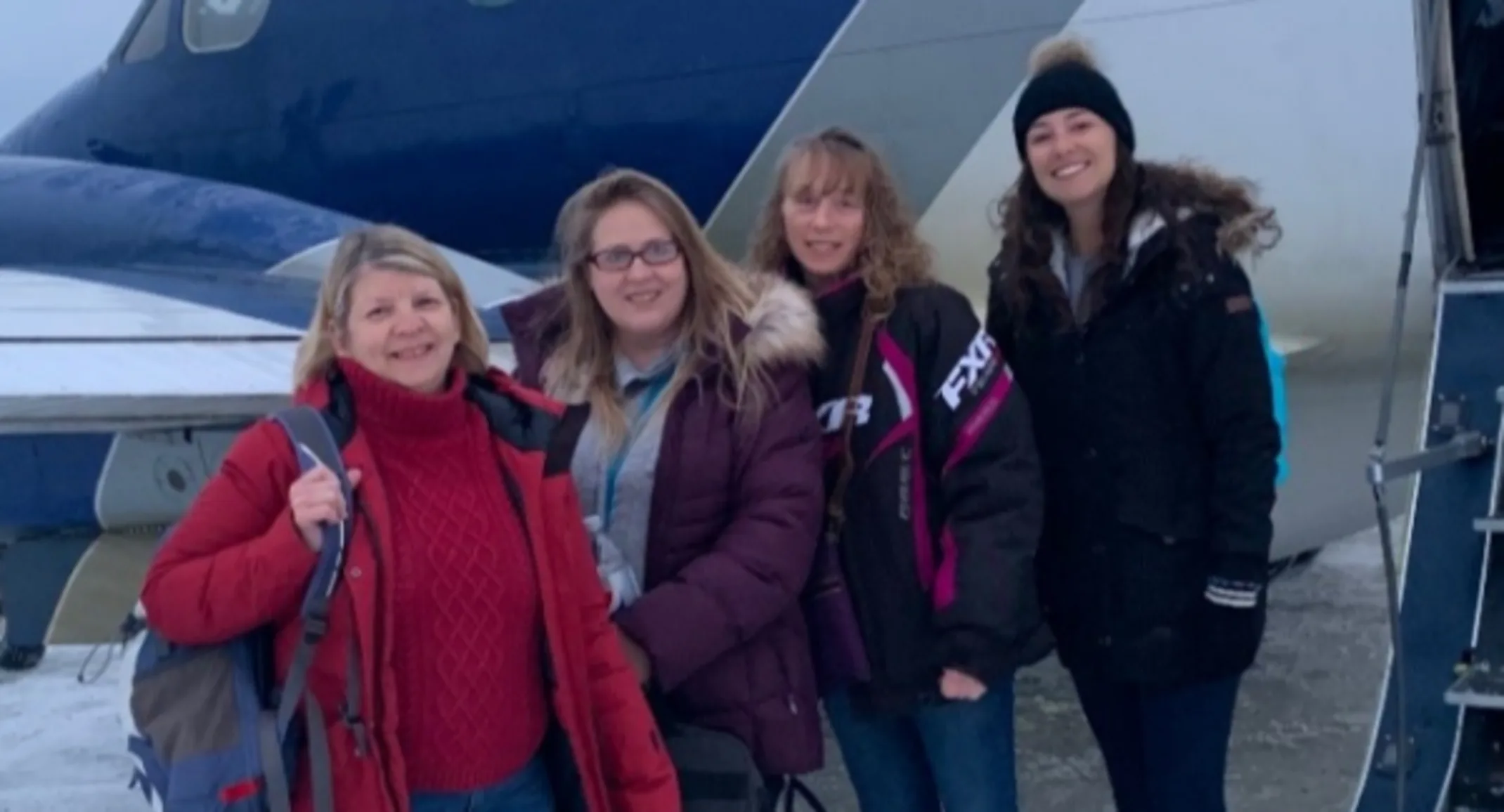 A photo of Allandale's staff posing in front of a plane in Peawanuk A photo of Allandale's staff posing in front of a plane in Peawanuk