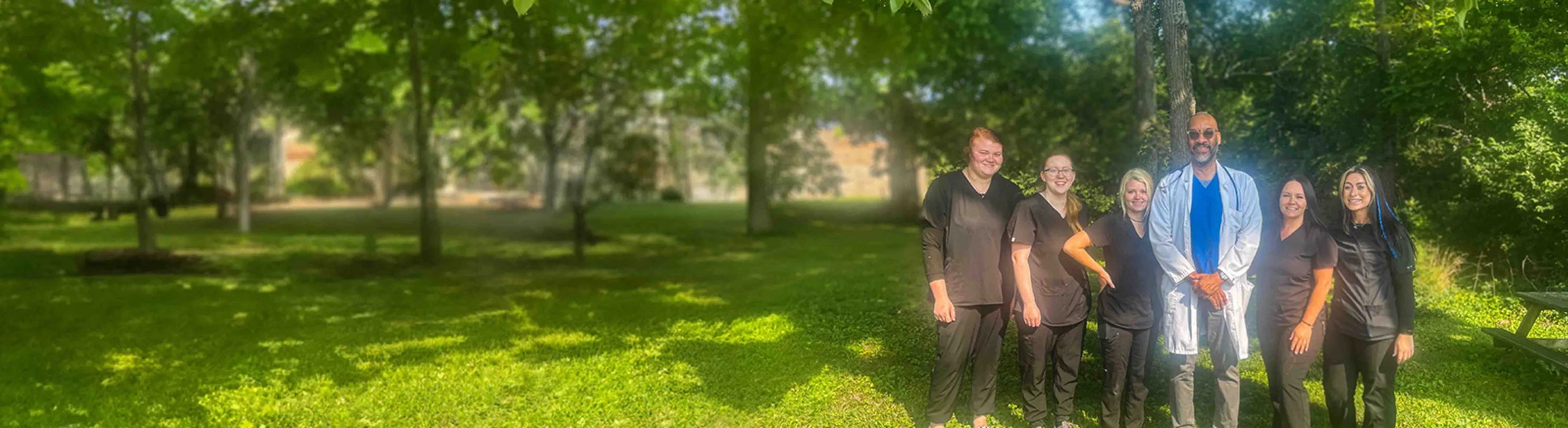 Staff posing for a photo outside of the hospital