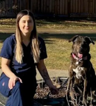 Kenzee sitting next to a brown and white dog Kenzee sitting next to a brown and white dog