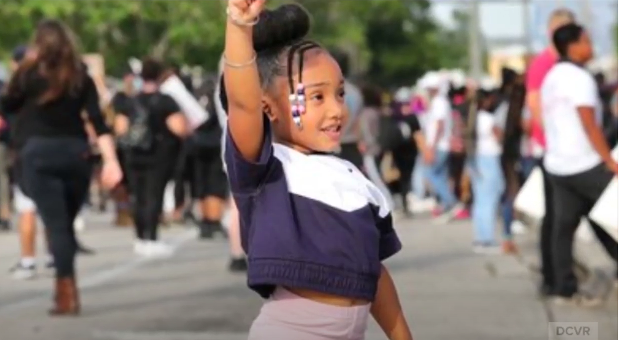 Young girl holding up her fist