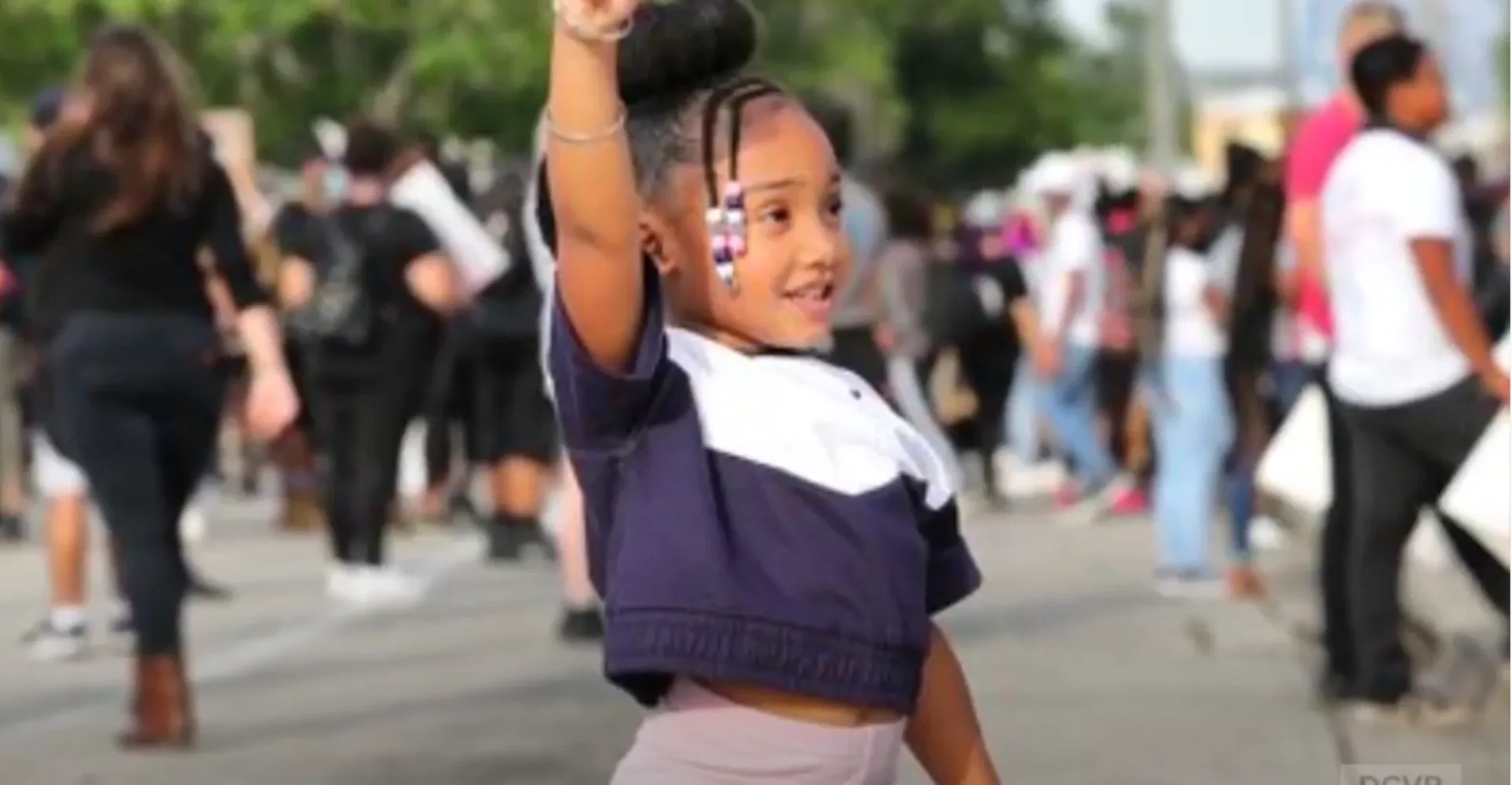 Young girl holding up her fist