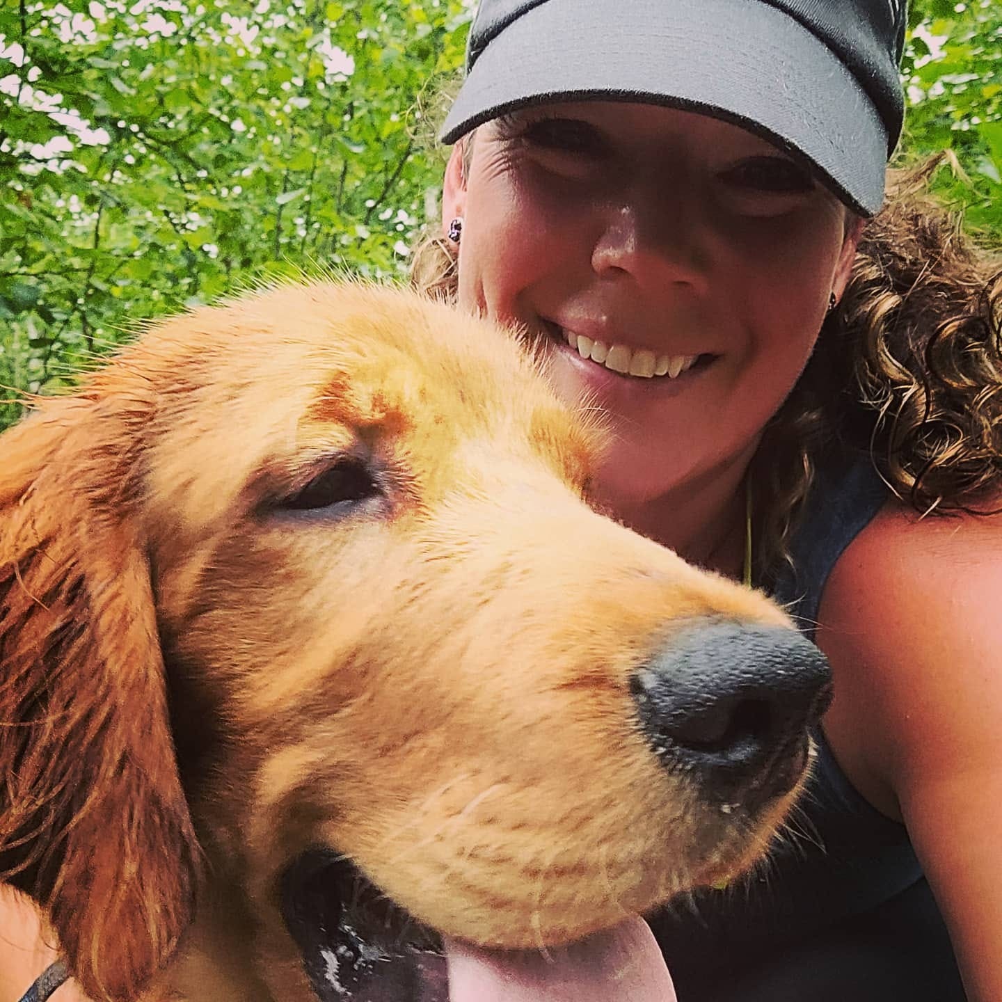 Staff photo of Kathryn and her Irish Golden/Irish Setter dog named Briggs O'Darby