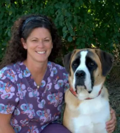 Christa kneeling next to a large dog Christa kneeling next to a large dog