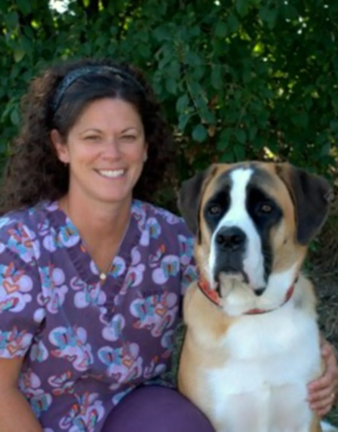 Christa kneeling next to a large dog Christa kneeling next to a large dog
