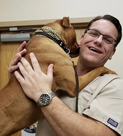 Chris Oldt hugging a brown dog Chris Oldt hugging a brown dog