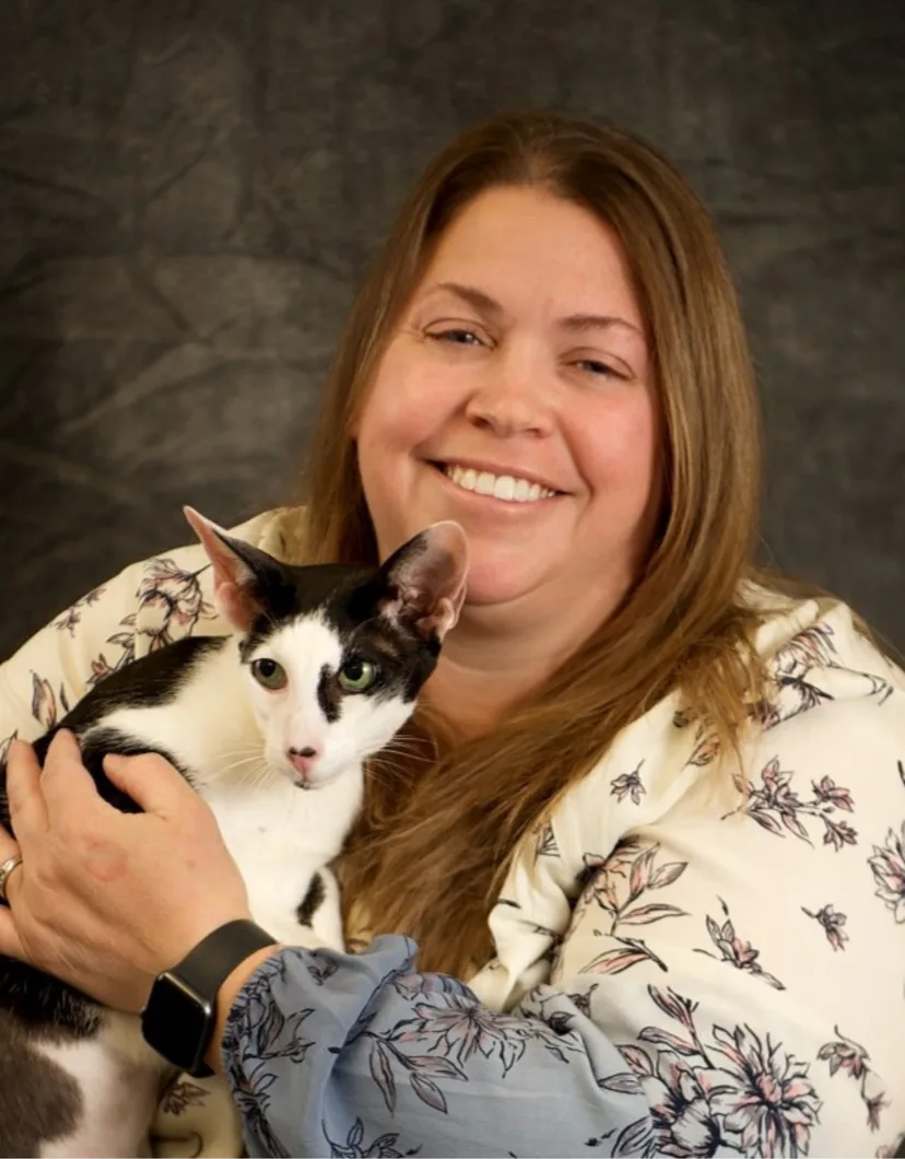 Dr. Jill Kitson holding black and white cat