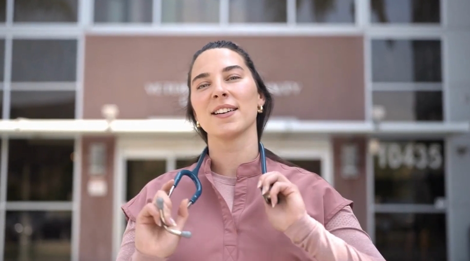 Staff member putting a stethoscope around her neck.