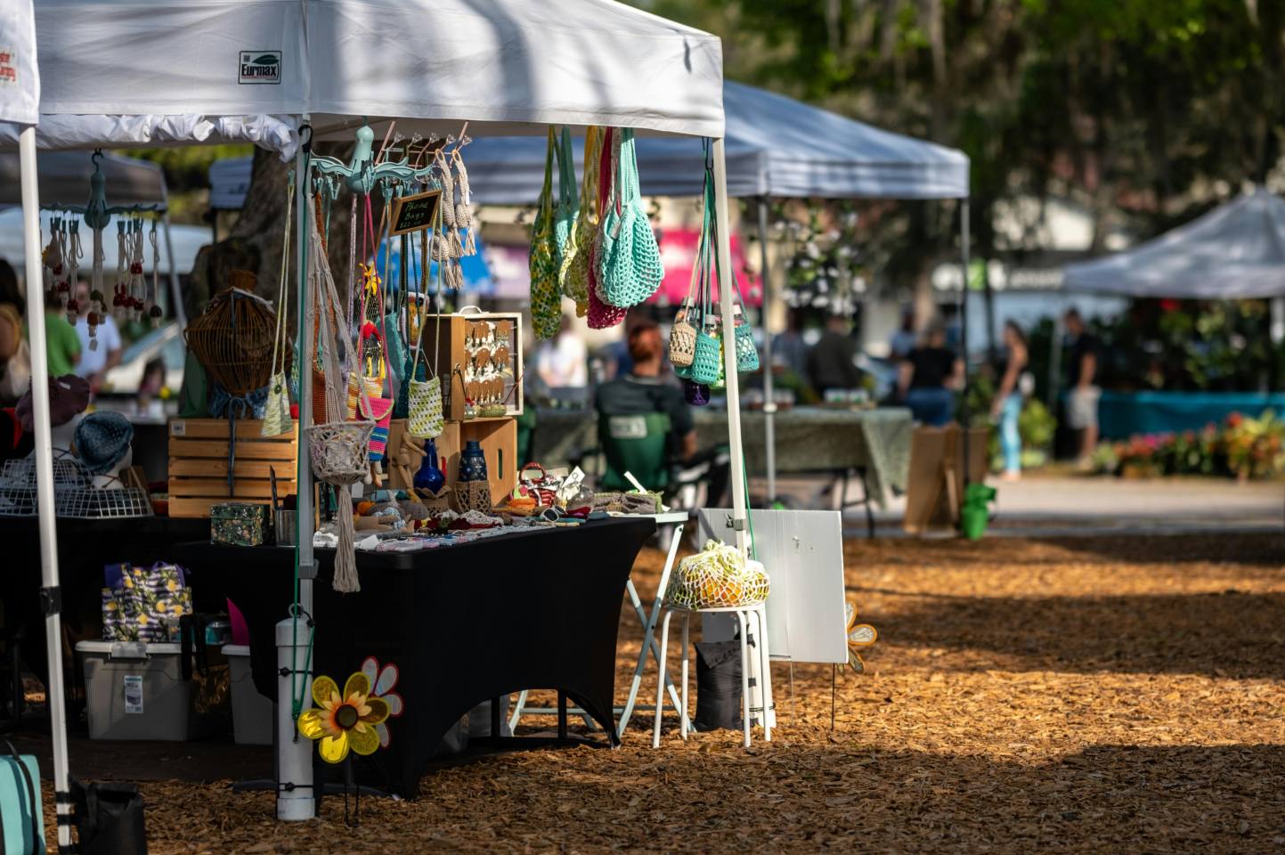 Pop-up tents lined with jewelry and crafts.