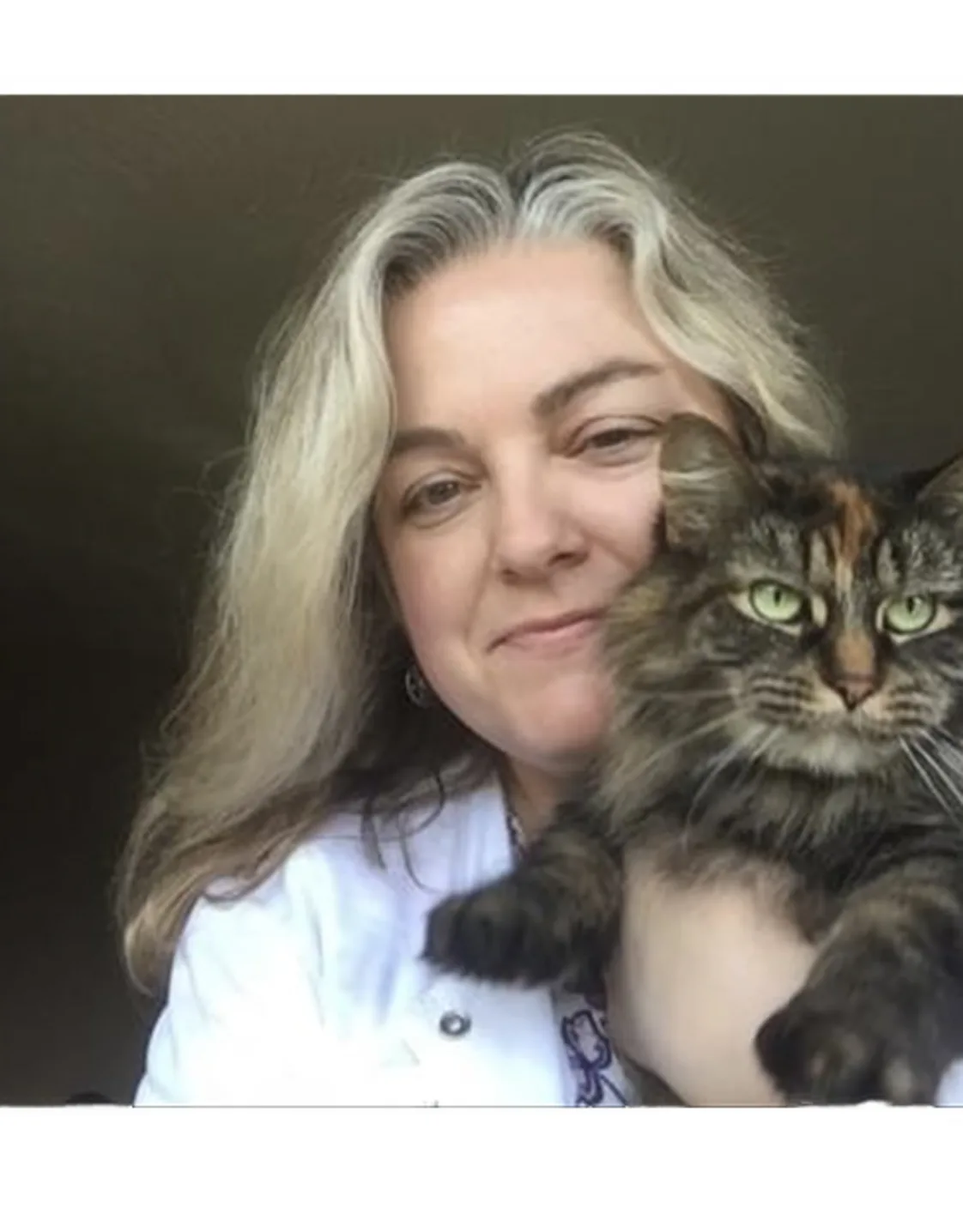 Dr. Janeen Junaid holding a tabby cat Dr. Janeen Junaid holding a tabby cat