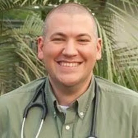 Dr. J.T. Gasson smiling outside