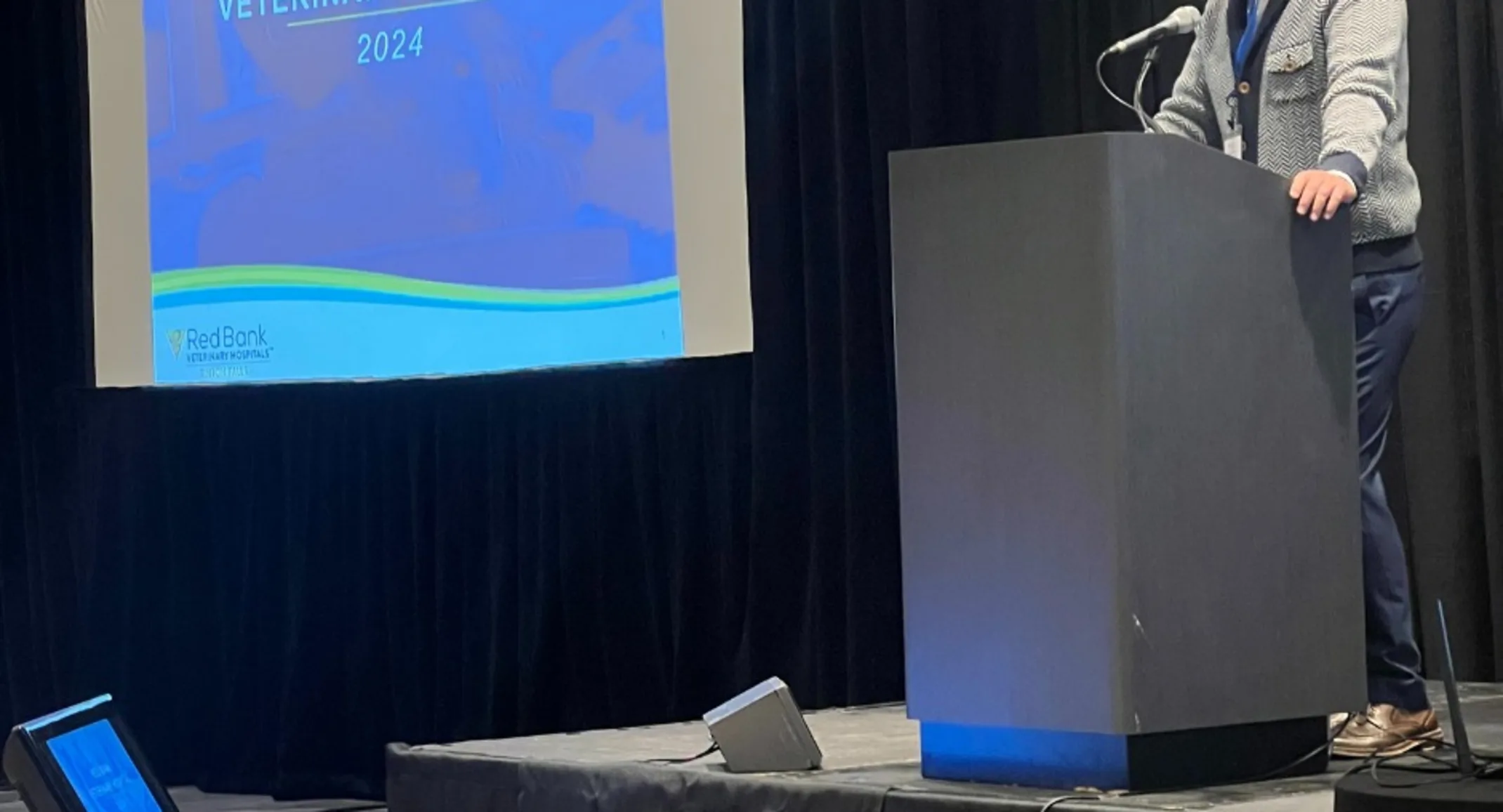 Host speaking at a CE Symposium Host speaking at a CE Symposium