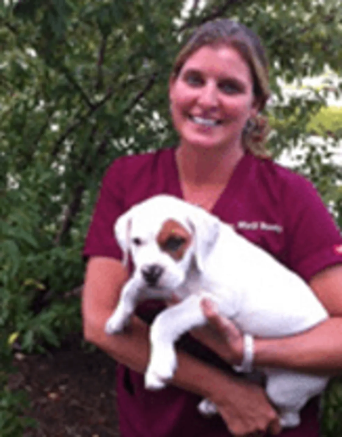 Dr. Marji Bundy with a dog. Dr. Marji Bundy with a dog.