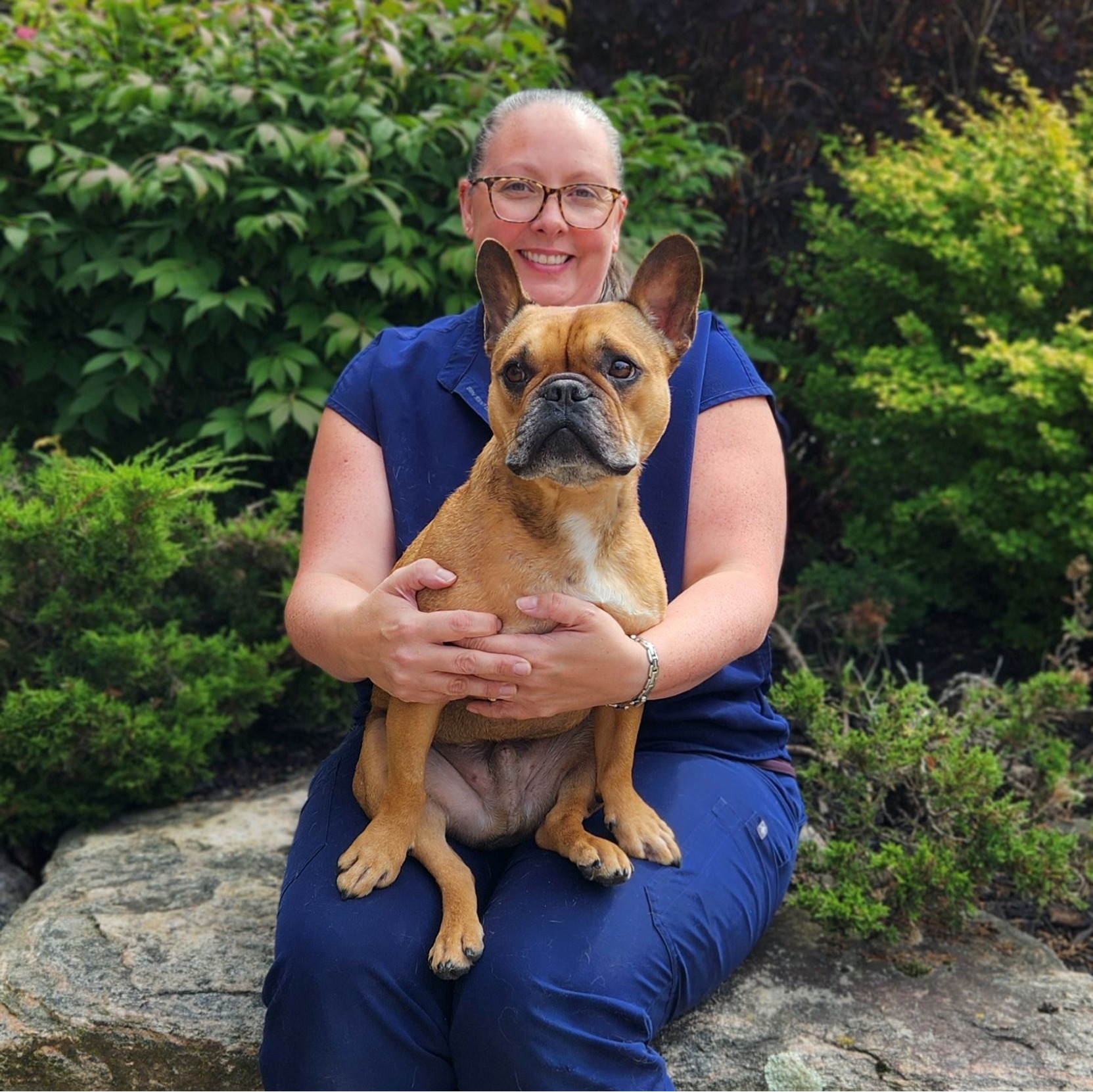 Leslie sitting with her dog, Gus