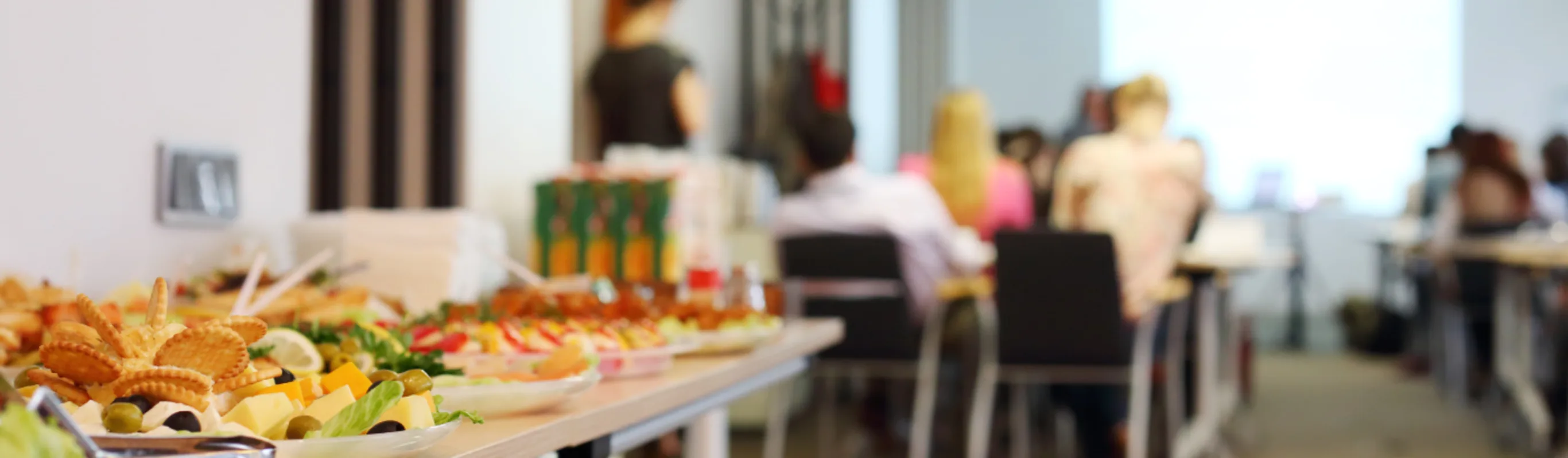 Food placed in front of a room of people Food placed in front of a room of people