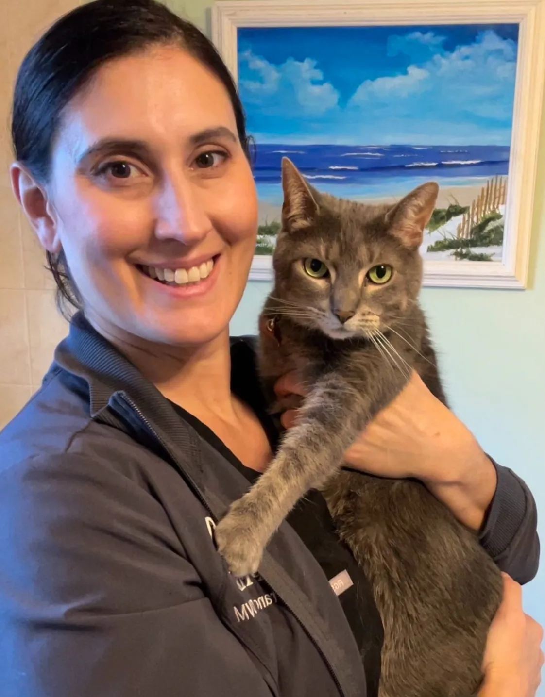 DVM Jessica Francisco smiling with a cat DVM Jessica Francisco smiling with a cat