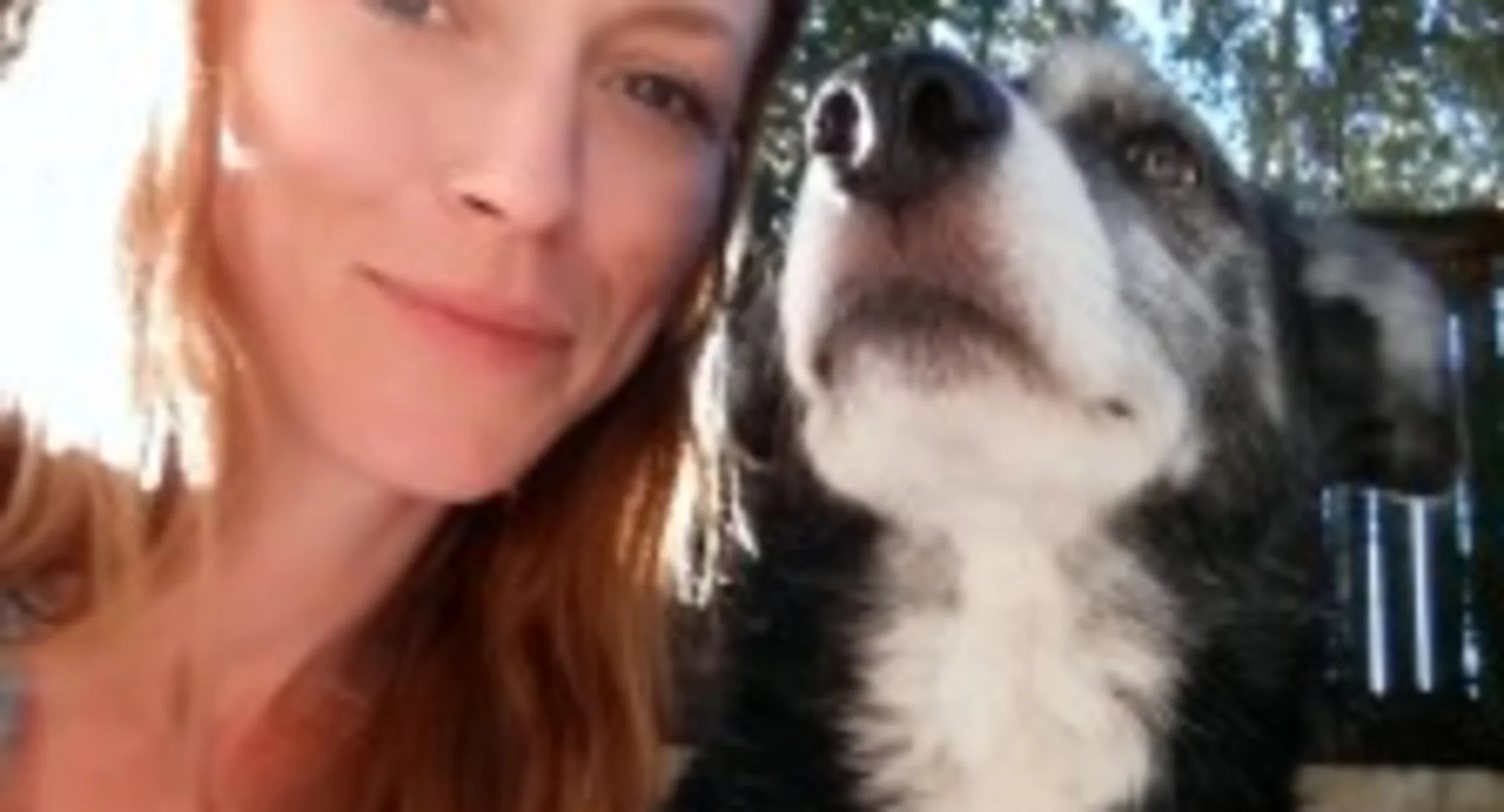 A woman poses with a dog A woman poses with a dog