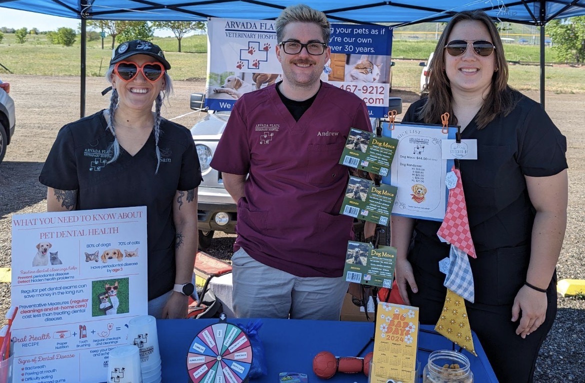 Three team members at the Arvada flats veterinary hospital event table