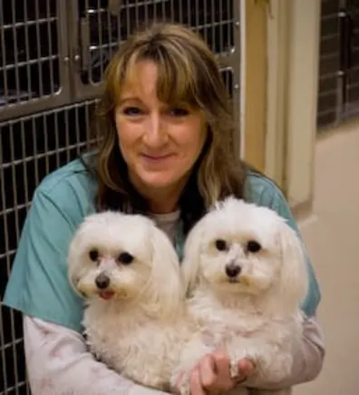Mary holding 2 small white dogs Mary holding 2 small white dogs