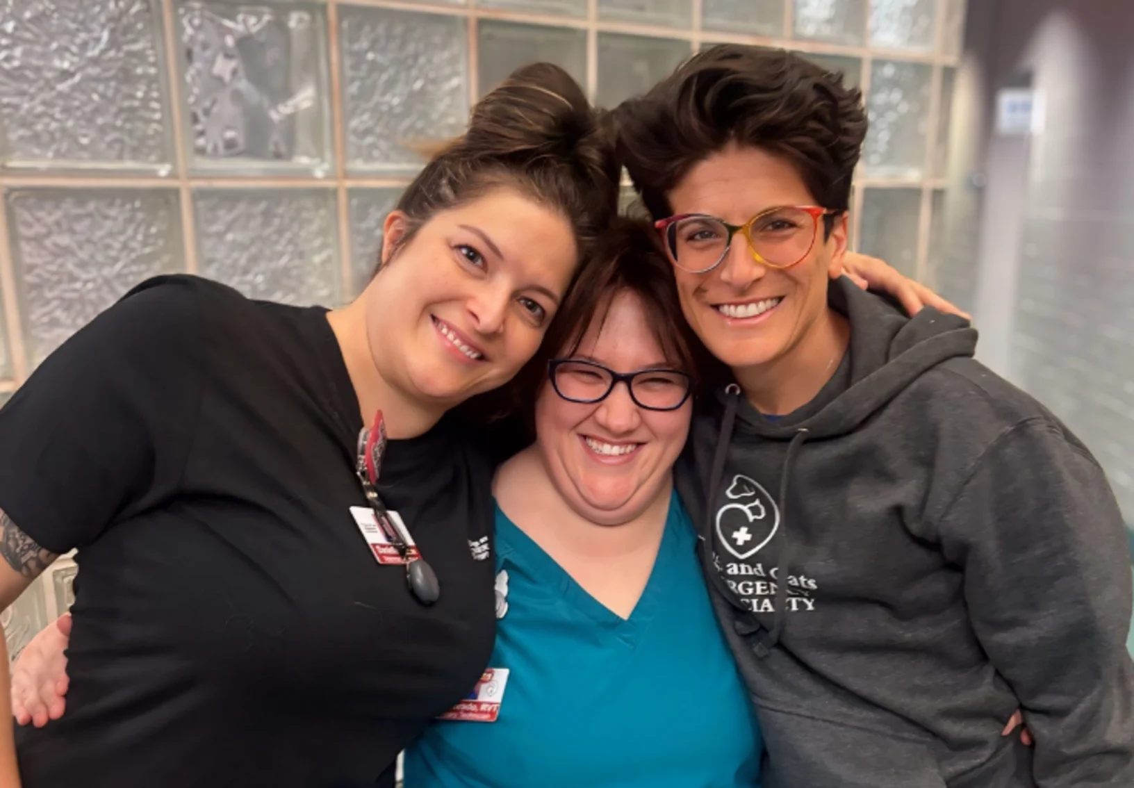 Three staff members smiling Three staff members smiling