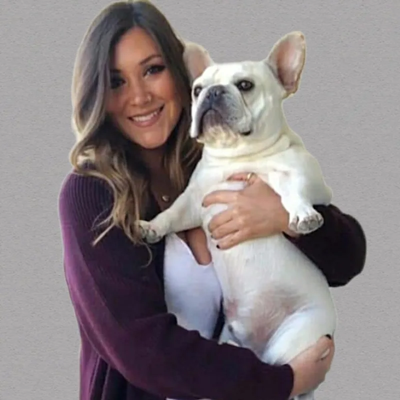 Dr. Jennifer Oesterling holding a white french bulldog. Dr. Jennifer Oesterling holding a white french bulldog.