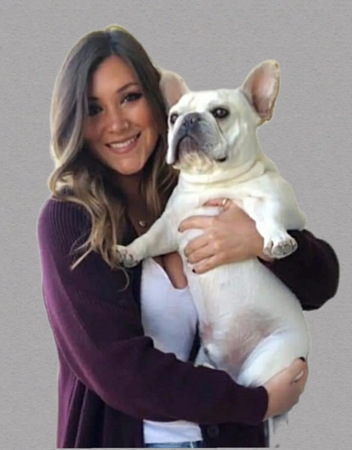 Dr. Jennifer Oesterling holding a white french bulldog. Dr. Jennifer Oesterling holding a white french bulldog.