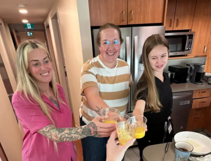 Staff holding celebratory drinks. Staff holding celebratory drinks.