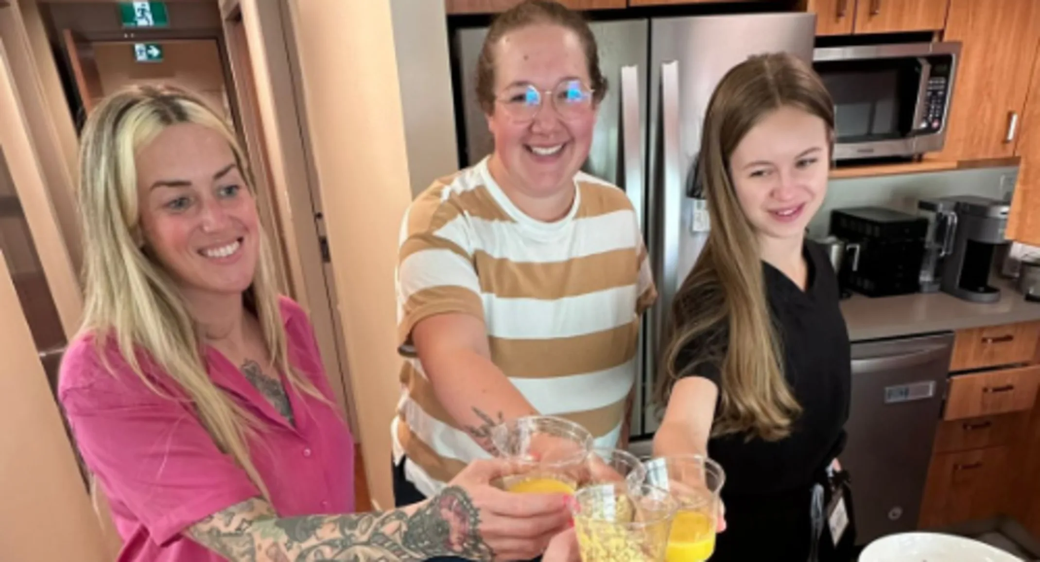 Staff holding celebratory drinks. Staff holding celebratory drinks.