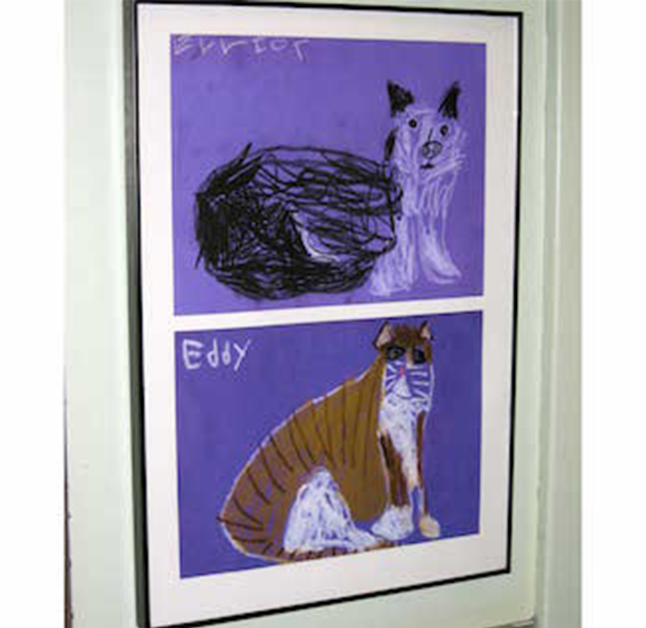 Two drawings of cat framed on the wall