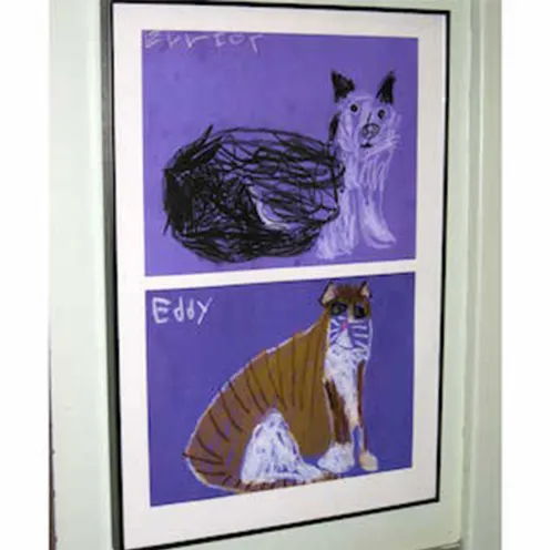 Two drawings of cat framed on the wall